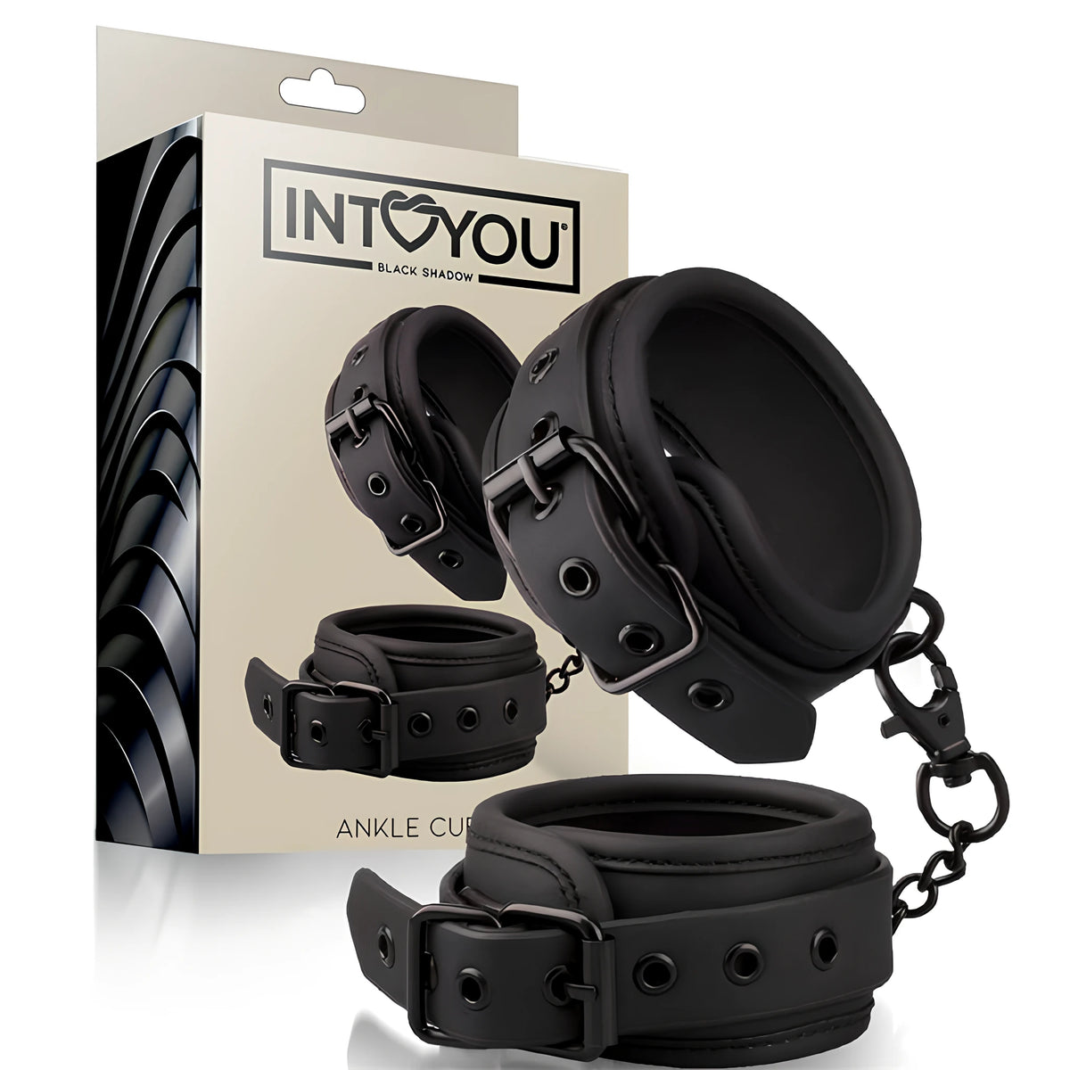 Белезници за крака Black Shadow на IntoYou в черно, с катарами и метална верижка, пред бежавата им кутия с надпис Ankle Cuffs