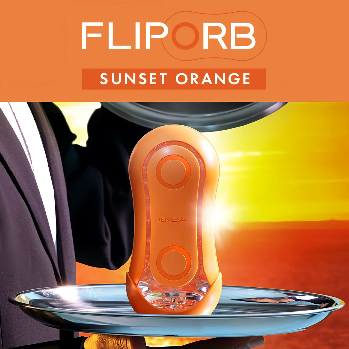 Рекламен кадър на оранжевия TENGA FLIP ORB Sunset Orange върху сребърен поднос, държан от сервитьор, на фона на залез