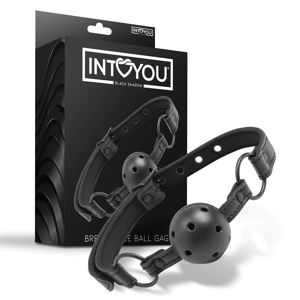 Черен наустник Black Shadow на IntoYou с перфорирана топка и каишка с метални халки, показан пред черната си кутия с лого