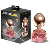 Анален разширител Pink Rose размер S: сива кутия AfterDark и пред нея розовозлатист метален аксесоар с розова роза в основата