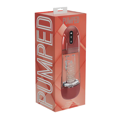 Кутията на SonicPull Red в червено-корал с надпис PUMPED; през прозрачния прозорец се виждат червеният уред и бутоните му
