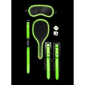 BDSM комплект Glow in the Dark на Shots: маска за очи, топка за уста, палета, белезници и две зарчета, всички с неоново зелени кантове на черен фон