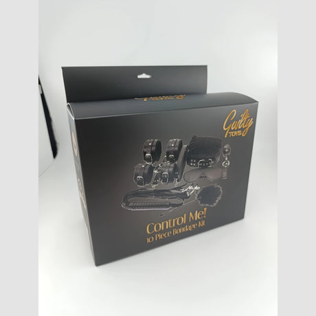 Черна кутия на BDSM комплект Control Me! 10 Piece Bondage Kit на Guilty Toys, под ъгъл, със златен надпис и изобразено съдържание
