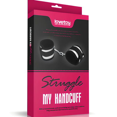 Розово-черна кутия на белезници Lovetoy Struggle My Handcuff с изображение на черни меки белезници с бели ленти и метална верига