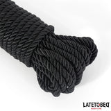 Close-up на навитото черно усукано въже Fetish Addict 10 м с лъскава повърхност, с логото LATETOBED BDSM Line долу вдясно