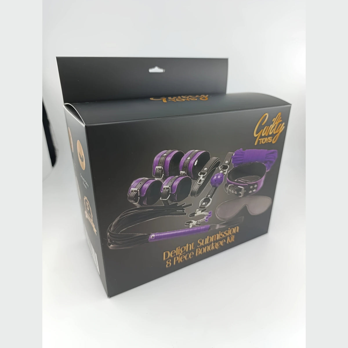 Черна кутия на комплект Guilty Toys Delight Submission 8 Piece Bondage Kit с лилави и черни аксесоари, заснета отстрани под ъгъл