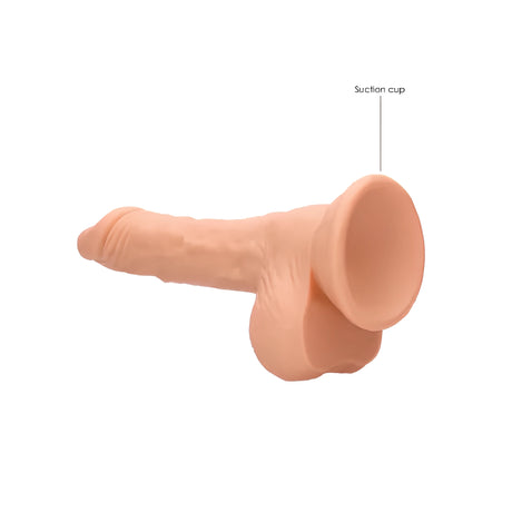 Дилдо Real Rock 17 cm в телесен цвят, страничен изглед с надпис "Suction cup", сочещ към вакуумната основа