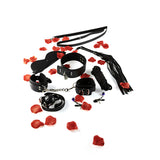 Всички части на комплект Amazing Bondage Sex Toy Kit на ToyJoy в черно, подредени сред червени розови листенца