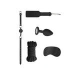 Комплект Introductory Bondage Kit No 5 на Ouch! в черно: каишка с топка, шило, украсена тапа, въже и превръзка за очи, подредени на бял фон