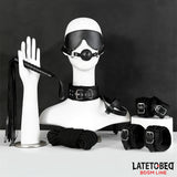 Комплект LateToBed BDSM Line от 7 части в черно: превръзка за очи с топка, нашийник, камшик, въже и маншети, подредени на манекени