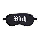 Черна сатенена маска за очи Bitch на Ouch! с ластична лента, отпред с бял готически надпис „Bitch“, на бял фон