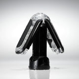 Tenga Flip Zero BLACK в отворено положение върху черна стойка: черни панти и прозрачен гелен корпус със светъл фон