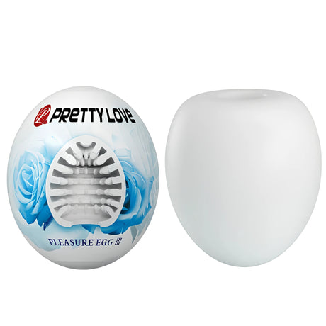 Pretty Love Pleasure Egg III: яйцевидна опаковка със сини рози и отвор, показващ вътрешната текстура, до бялото яйце извън нея