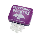 Лилава метална кутийка Peppermint Peckers с надпис „Willie shaped mints“ и разсипани бели ментови бонбони пред нея – изглед 2