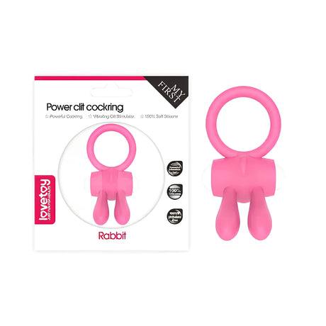 Пенис ринг Power Clit Pink на Lovetoy: розов силиконов ринг с два ушенца до своята картонена опаковка с надпис Rabbit