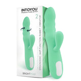 Вибратор IntoYou Brightpear в мента зелено до бялата си кутия с надпис „Ergonomic 360° function rabbit vibrator“ и 2 мотора