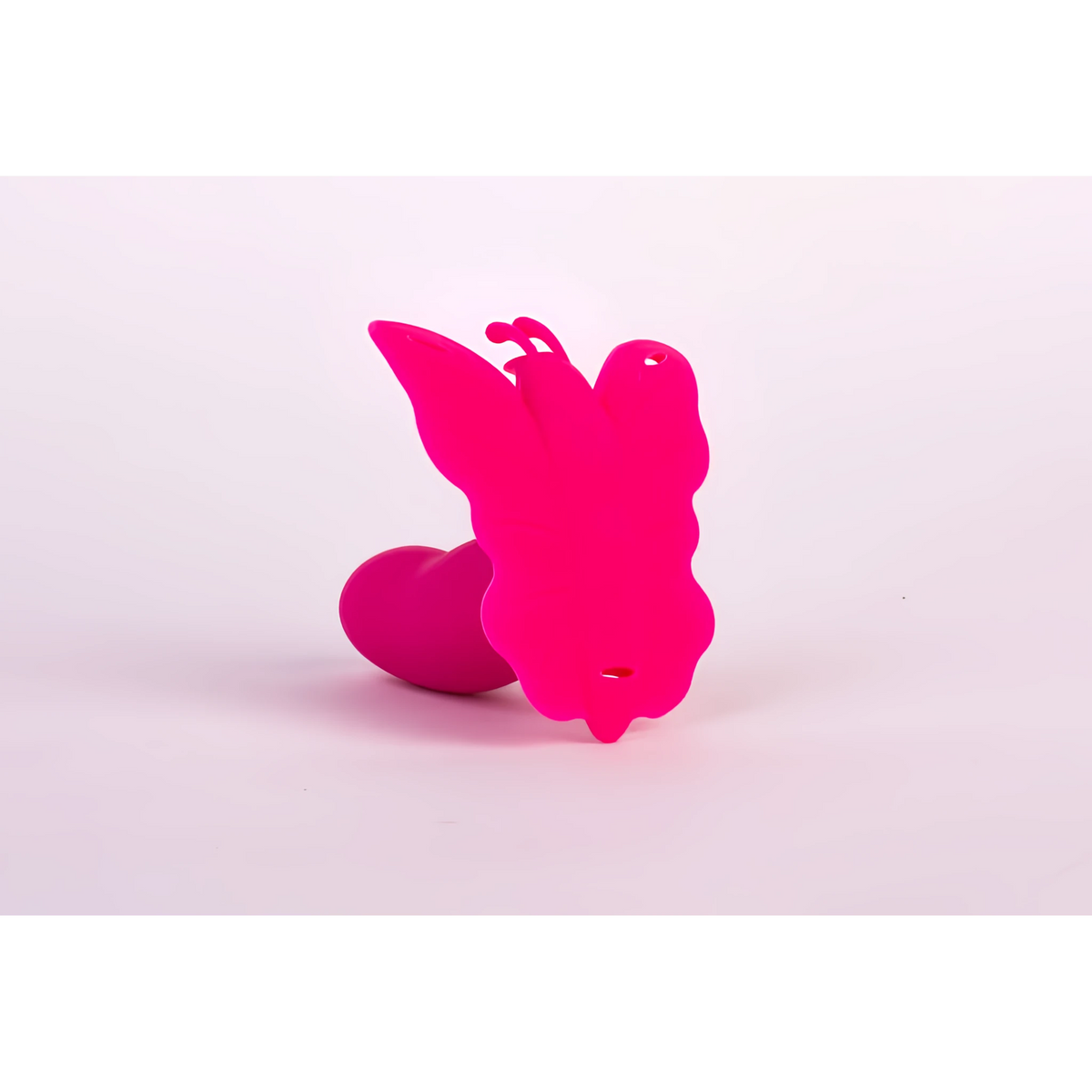 Розов силиконов стимулатор Lydia I Smart Butterfly на Realov с форма на пеперуда, сниман отзад на светъл фон