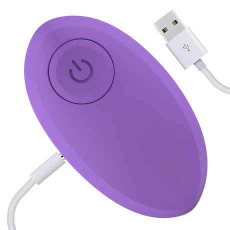 Лилавото виброяйце Odise с бутон за включване, свързано към бял USB кабел за зареждане